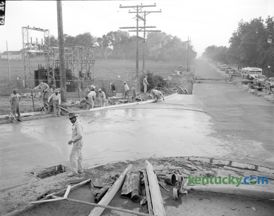 Workmen pictured as they finished first half of new concrete on Nicholasville road at its junction with Rose and Limestone streets.  Nov. 14, 1946