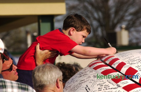 Five-year-old Blake Barhorst from Morehead is held by his dad Tod as he signs the giant baseball at the Lexington Legends home opener at Applebee's Park April 9, 2001. The Legends are a single-A minor league baseball team that started as an affiliate of the Houston Astros, but are now part of the Kansas City Royals farm system. In their inaugural season, the Legends made it to the South Atlantic League Championship Series, however the series was canceled after two games because of the Sept. 11 terrorists attacks. The Legends were named co-league champions with the Asheville Tourists.