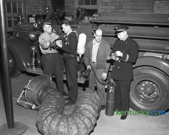 Lexington Fire Department personnel inspecting new equipment Dec. 12, 1950.  From left, W. T. Kerns, E. F. Petit, Jimmy Smith and Fire Chief Earl McDaniel. 