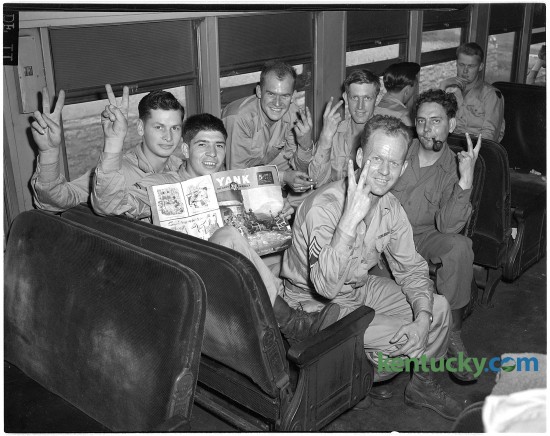 86th Division soldiers giving peace sign on train en route from Camp Kilmer, New Jersey to Camp Atterbury, Indiana.  Pictured clockwise are Staff Sergeant Eugene A. Hughes, Richmond; Private First Class Ova Helton, Hazard; Private First Class Frankie Vice, Williamstown; Private First Class Clifton Ray, Lancaster; Private First Class John S. McKenzie, Paintsville, and Private Jarnet Simmons, Hindman.  Published in the Lexington Herald June 21, 1945. Lexington's 2014 Fourth of July festival's  theme is “Celebrate Heroes,” to honor all those who help keep the nation and cities safe.