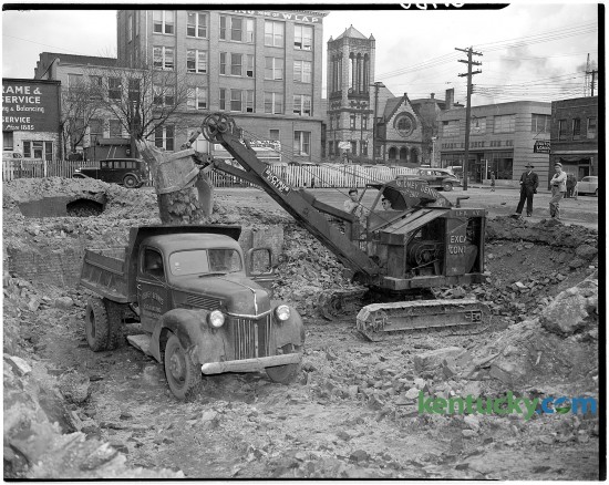 Excavation of the west portion of the old post-office lot begun at Main and Walnut streets in March of 1946, for the construction of new Martin's Blue Grass Fashions store.  Walnut St. is now called Martin Luther King Blvd. In the background is a Sears-Roebuck store and Central Christian Church.
