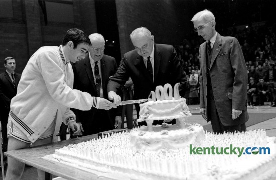 From left, UK basketball team captain Phil Argento, 1905-07 team member Thomson Bryant, UK coach Adolph Rupp, and Wylie Wendt, manager of the 1906 team, cut a large cake Jan. 13, 1969 as the Wildcats officially celebrated 1,000 basketball wins dating back to Feb. 18, 1903. 