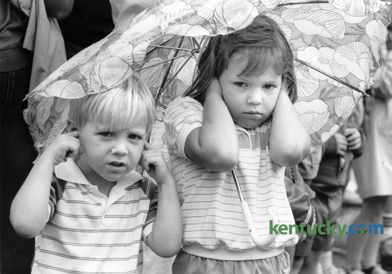 Richard Mattmiller, 4 and sister Karol Mattmiller, 5, held their ears as semi-trucks blowing their horns passed them during the downtown parade on July 4, 1984. Photo by Gary Landers Herald-Leader staff