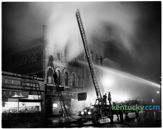 A fire damaged the Eagles Club at 139 North Broadway in March of 1950. Lexington fire fighters fought to extinguish the flames. The building was saved and is currently the law offices of Garmer & Prather, PLLC. To the right is the Lexington Opera House. Published in the Lexington Herald March 30, 1950. 