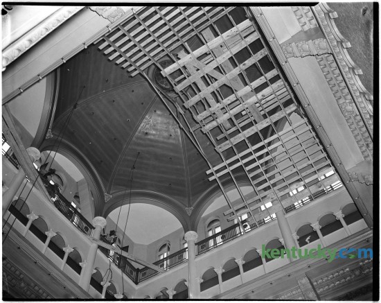 In 1944 the interior of the Fayette County courthouse dome was repaired and painted.  This photo showed workers putting up scaffolding prior to making the repairs. Construction on this, the fifth Fayette County Courthouse, began in July of 1898 and was finished February 1, 1900. The new courthouse was a Richardson Romanesque style, a three-story stone masonry building, with a dome, clock and cupola (with weather vane). In 1960-1961, the interior of the courthouse was extensively renovated, to provide more courtrooms and offices.  These renovations included the removal of the interior ÒYÓ stairs and closing off the dome. The last trial was held in the courthouse in 2002 and in 2003 the Lexington History Center opened. During 2012, the courthouse was closed to the public due to lead paint and asbestos found in the upper floors.  Proposals are under currently under consideration to restore the courthouse to the original design. Published in the Lexington Leader June 29, 1944. Herald-Leader Archive Photo