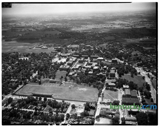 Aerial view of the University of Kentucky campus, 1945-1946. Avenue of Champions runs left to right near the bottom of the photograph with Stoll Field and McLean Stadium, center, lower left. It was the home of the University of Kentucky Wildcats football team. The field hasd been in use since 1880, but the concrete stands were opened in October 1916, and closed following the 1972 season, and was replaced by Commonwealth Stadium.  This was taken prior to Memorial Coliseum which was built in 1950.  