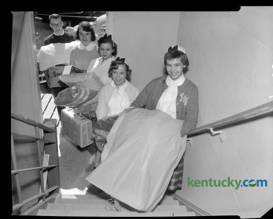 Transylvania College coeds moved into Forrer Hall, new women's dormitory at Transylvania in the fall of 1958.  From front to back are Kitty Winkler, Ritchey Eldred, Betty Ann Snyder, and Joy Stinnett. Young man is unidentified. Published in the Lexington Leader  October 2, 1958. 