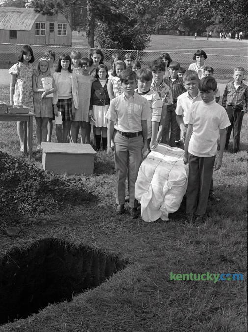 Dorothy Hellard's sixth grade class at Picadome Elementary  School prepared to bury a time capsule containing about 200 items on Friday  May 31, 1968. The container was buried in a concrete vault  and among the items it contained were bubble gum, a calendar, tape recording of students  voices, a city map signed by Mayor Fred Fugazzi, a card from the  White House signed by President Lyndon Johnson and a Kentucky flag signed by  Governor Louie Nunn. The time capsule was unearthed in 2004 when a backhoe was working near the school. Students contributed additional items from 2004 and the capsule was reburied.  Photo by Frank Anderson | Staff