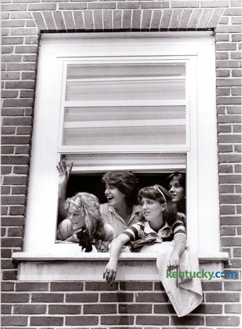 Four incoming University of Kentucky freshmen waved at friends from a third floor window of Jewell Hall in August of 1980. From left are Kim McClaskey, Rochester, NY, Sandy Pulsfort, Ft. Thomas, Ky., Michele Stephens, Verona, Ky., and Missy Embree, Long Island, NY. Photo by Christy Porter | Staff