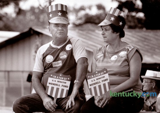 Randle Darnell and Marge Eastin, both of Benton, Ky., showed their support for several candidates as the waited for the speeches to begin at the 106th Fancy Farm Political Picnic at St. Jerome's Church in Fancy Farm, Ky., August 2, 1986. Photo by Charles Bertram | Staff