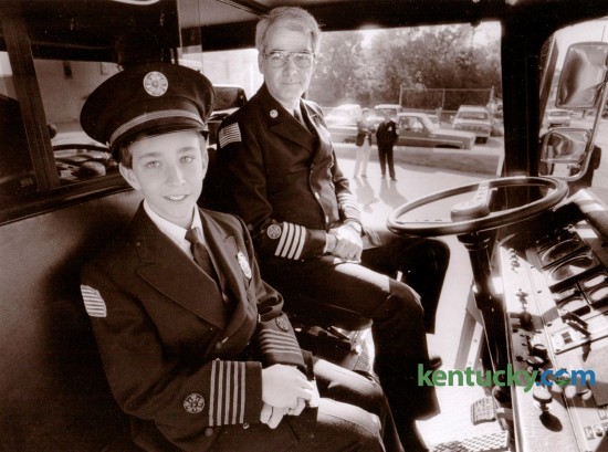 Colby Justice, 11, a sixth grader at Squires Elementary School was named Lexington' s Junior Fire Chief in October of 1988. Justice, son of Richard and Ann Justice, sat in the cab of the snorkel truck at Station One with Lexington Fire Chief Gary McComas on October 7, 1988. Photo by Michael Malone | Staff