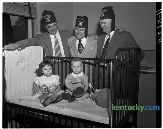 University of Kentucky basketball coach Adolph Rupp, left, Charles Galloway Calhoun, Shriners imperial potentate and Fred Bryant posed for a picture at Shriner's Hospital in Lexington with Barbara Scully and Gary Meadows in June of 1949. Published in the Lexington Leader June 23, 1949. 