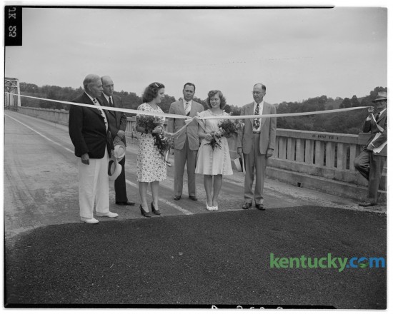 Judge V.W. Bush, of Winchester, William Caywood, Patricia Ann Moore, Lieutenant Governor Kenneth H. Tuggle, Mary Elizabeth Moore and B.E. Willis at the freeing of the Boonesborough bridge over the Kentucky River in August of 1945. Published in the Herald-Leader August 26, 1945. 