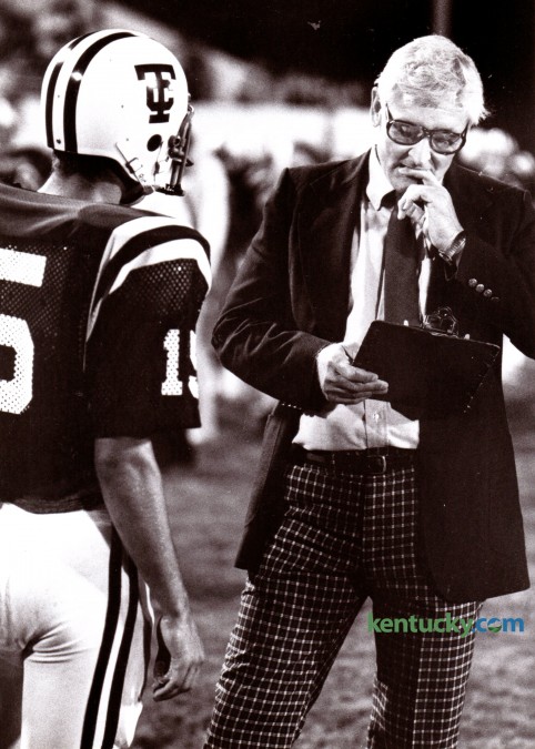 Tates Creek High School football coach Roy Walton talked with quarterback Ronnie Long during a game on September 5, 1980. The long-time Tates Creek coach accumulated most of his 219 victories in 26 years of coaching there. He led the Commodores to an undefeated season and state championship in 1972 and an at-large state title in 1978. He retired after the 1992 season. Walton died in 2010 at age 80. Photo by Ron Garrison | Staff