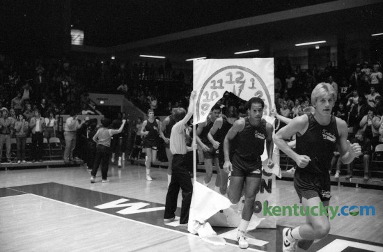 The University of Kentucky's first "Midnight Practice", later called Midnight Madness, occurred October 14, 1982 in Memorial Coliseum. Troy McKinley, right, and Derrick Hord led the way through a paper banner that read "The Cats will Run at 12:01." Photo by E. Martin Jessee | Staff