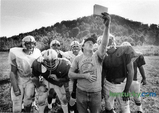 Corbin High School football coach Larry "Cotton" Adams checks out a play with his team during practice Sept. 27, 1983. Adams played for Corbin in the early 1960s and served as an assistant for 13 seasons before moving up to head coach in 1981. His 14-year record was 114-46, highlighted by a Class 2A state championship in 1982 and a runner-up finish in 1990. The 2014 Redhounds take on Central in the third round of the Class 3A playoffs today. Photo by Charles Bertram | staff.
