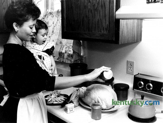 Sandra Ashley-Johnson and her daughter Leah prepare a turkey for Thanksgiving Nov. 24, 1985. Photo by Tom Woods | staff