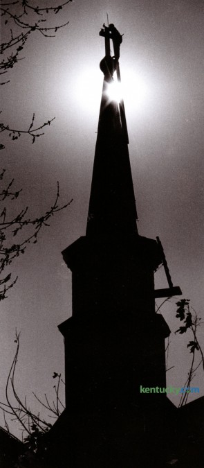 Phillip Quinn of Lexington, a self-employed steeple jack, worked to repair the cross on top of the steeple of the Catholic Church of the Annunciation in Paris, Ky. November 9, 1989. Photo by Clay Owen