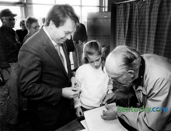 Nine-year-old Alison Lundergan joined her father, Kentucky 76th district representative Jerry Lundergan, as he prepared to sign-in to vote at the Eastland precinct Nov. 8, 1988. Photo by Charles Bertram | staff
