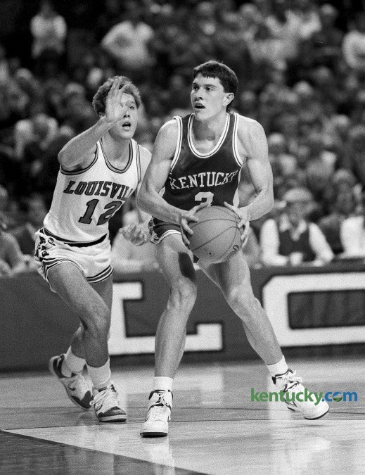Kentucky basketball player Rex Chapman drove past Louisville's Craig Hawley during the Cats 85-51 win Dec. 27, 1986 in Louisville. Chapman, a freshman,  lit the Cards up for 26 points, hitting 10 of his 20 shot attempts. Despite playing only two years at Kentucky, Chapman is 50th on UK's all-time scoring list with 1,073 points. In 1988 he was drafted eighth overall by the Charlotte Hornets. Photo by Tim Sharp | Staff