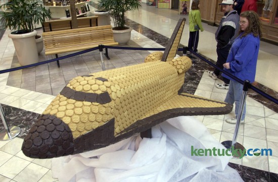 Ann and Kevin Grimes, from Wilmore, checks out a space shuttle made of girl scout cookies, designed by GBBN Architects as part of a Girl Scout Cooke Contruction Contest on display at Fayette Mall in Lexington, on March 5, 2001. The contest, sponsored by the Girl Scouts - Wilderness Road Council, American Institute of Architects and Fayette Mall, featured other designes and visitors to the mall could vote for their favorite. Photo by David Stephenson