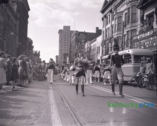A drum major for a high school band (WHS) shown in a parade for a music festival on Main Street in 1940 or 1941.  The Strand theater is in the background The movie Santa Fe Trail, which came out December 28, 1940, starring Errol Flynn, Olivia de Havilland, Raymond Massey and Ronald Reagan was showing at the Strand. The 1,356-seat theatre opened in 1915 and closed in 1974, then demolished to make way for an office building. Unpublished. 