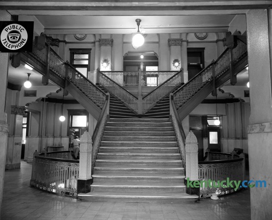 Interior of the Fayette County Courthouse in August of 1960 showing the Y-shaped stairwell that led to offices and court rooms on the second and third floors.  Construction on this, the fifth Fayette County Courthouse, began in July of 1898 and was finished February 1, 1900. The new courthouse was a Richardson Romanesque style, a three-story stone masonry building, with a dome, clock and cupola (with weather vane). In 1960-1961, the interior of the courthouse was extensively renovated, to provide more courtrooms and offices.  These renovations included the removal of the interior Y stairs and closing off the dome. The last trial was held in the courthouse in 2002 and in 2003 the Lexington History Center opened. During 2012, the courthouse was closed to the public due to lead paint and asbestos found in the upper floors.  Proposals are under currently under consideration to restore the courthouse to the original design. Published in the Lexington Herald-Leader August 28, 1960. 