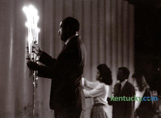 Lewis Stout, left, helped light candles during a Martin Luther King, Jr. Memorial Service in Memorial Coliseum on the University of Kentucky campus, Sunday January 18, 1987. Photo by J.D. VanHoose | Staff