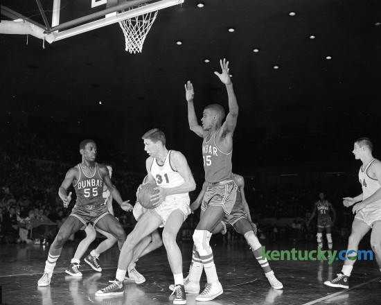 Lafayette's Jeff Mullins is surrounded by Dunbar's James Young and Felix Scruggs during the 11th regional high school basketball tournament in March, 1959. Dunbar won the game, 54-48. Published in the Herald-Leader March 14, 1959. Herald-Leader Archive Photo