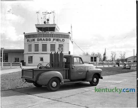 Crash equipment truck for Blue Grass Field with the terminal building and control tower in the background. Published in the Lexington Leader Feb. 15, 1954.