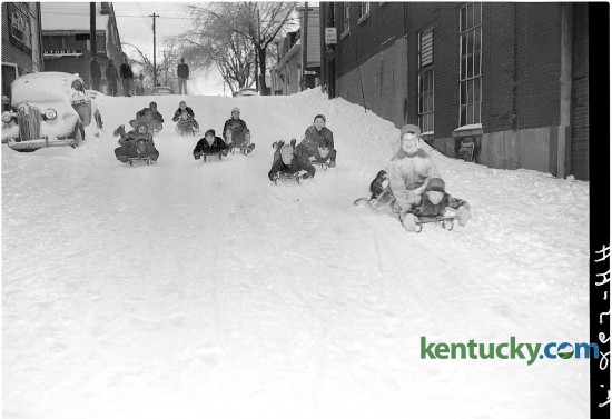 Children sled down a hill on Patterson Street in Lexington Feb. 1951. During a record cold snap that hit Lexington, the temperature went as low as minus-15 degrees. The brutal cold was part of the Great Storm of 1951, when rain and sleet on Jan. 31 was followed by deep cold and snow. The winter storm stretched from Louisiana to Ohio, but Kentucky and Tennessee received the brunt of it. Twenty-five deaths were blamed on the storm, which caused an estimated $100 million in damage — a record at the time. Published in the Lexington Herald February 5, 1951. Herald-Leader Archive Photo