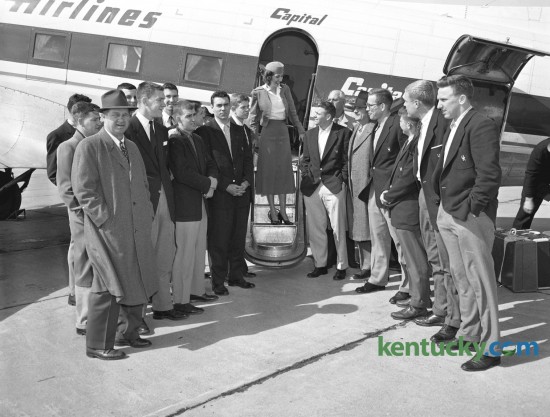 University of Kentucky (UK) basketball team arrived at Blue Grass Field March 2, 1954, after completing the regular season without a defeat.  The traveling party for the two-game trip to Auburn and Alabama included (not in order) Assistant Coach Harry Lancaster, Bill Bibb, Linville Puckett, Cliff Hagan, and Frank Ramsey, Peggy York (center, hostess for Capital Airlines), Gayle Rose, Coach Adolph Rupp, Bill Evans, Student Manager Mike Dolan, Willie Rouse, and Dan Chandler, Harold Hurst, Phil Grawmeyer, Hugh Coy, Sports Publicist Ken Kuhn;, Athletic Director Bernie Shively and Lou Tsioropoulos. Published in the Lexington Leader March 2, 1954. 
