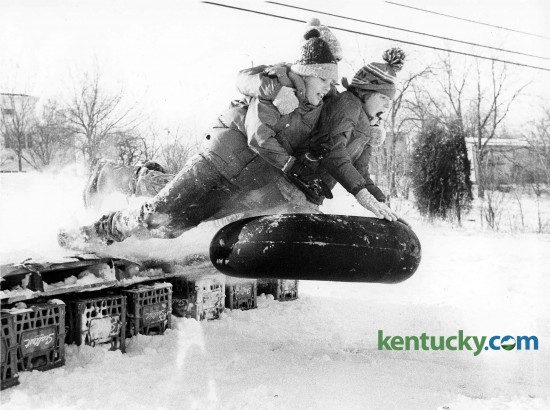 Tyler Callihan, Eddie Hightower and John Piper rode an innertube over a jump they made on a hill behind Lansdowne Shopping Center in Lexington, February 1979. Photo by Charles Bertram | staff