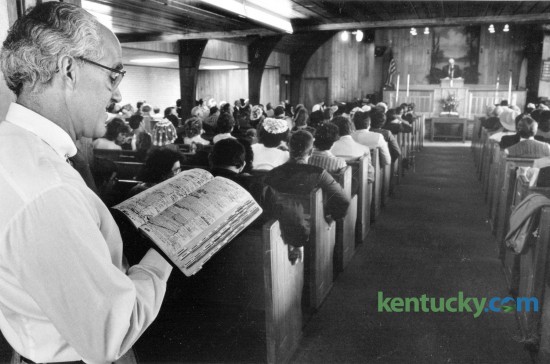 Usher Jerry Cassidy followed along in his bible as Reverend Al Gormley delivered his sermon at Bryan Station Baptist Church February 16, 1986. Photo by Gary Landers