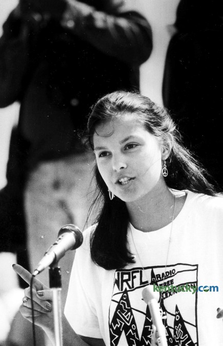 20-year-old Ashley Judd speaking at a April 14, 1988 protest march at the state capitol in Frankfort demanding the resignation of University of Kentucky trustee A.B. "Happy" Chandler." In the week prior, the 89-year-old Chandler used of a racial slur at the board's investment committee meeting. About 200 people marched on the state Capitol demanding Chandler's removal from the board. Gov. Wallace Wilkinson met the hostile crowd on the steps and urged forgiveness for Chandler, who had endorsed him in his 1987 gubernatorial campaign. Protesters booed Wilkinson when he said he would not remove Chandler from the UK board. Judd, the daughter of Naomi Judd and the sister of Wynona Judd, the award-winning country music duo from Ashland, told the crowd "I know Governor Wilkinson, and I think he was a little surprised because I was a white, middle-class person in this predominantly black crowd." Judd, then a UK sophomore majoring in history and French, rounded up students to join the march. She walked through the halls of classroom buildings pleading with students to leave their classes and join the rally. Shouting "Stop racism everywhere" and "Let's walk out and let's go to Frankfort," Judd and a few other members of the United Student Association for Racial Justice attracted about 50 UK students to make the trip to Frankfort. When Chandler celebrated his 90th birthday later in the year, he told a reporter he had no regrets about anything during his long and colorful public career. "I wouldn't change a jot or tittle," said Chandler, who died in 1991. Photo by Stephen Castleberry | Staff