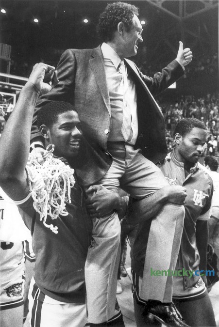 Kentucky basketball coach Eddie Sutton is carried off the court  by Richard Madison, left, and Winston Bennett following the Cats'  March  8, 1986 victory over Alabama, 83-72 in the finals of the SEC tournament at Rupp Arena in Lexington. Rupp Arean has hosted the conference tournament three times; 1982, 1986 and 1993. The Wildcats won two of those tournaments, only losing in the 1982 tourney finals by two points to Alabama. Photo by Charles Bertram | staff