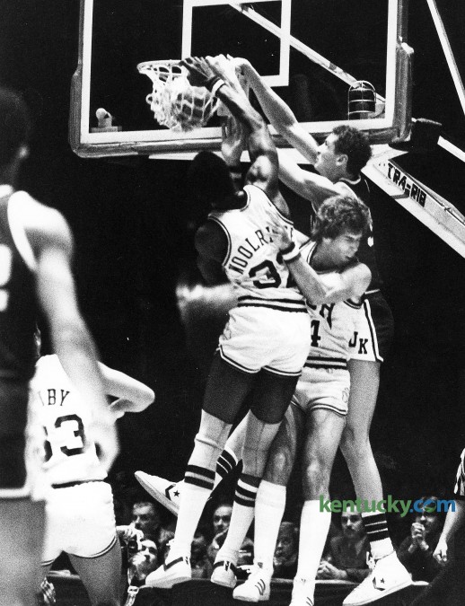 Kentucky's Sam Bowie dunks over Notre Dame's Orlando Woolridge, left, and Kelly Tripucka Dec. 27, 1980 at Freedom Hall in Louisville. Bowie led UK with 18 points but it wasn't enough as the eight-ranked Irish won, 67-61 behind Tripucka's 30 points and Woolridge's 15. It was the first defeat of the year for the No. 2 ranked Wildcats, who would go on to finish the season with two consecutitive losses en route to a 22-6 record. Photo by E. Martin Jessee | staff