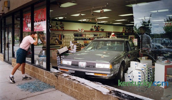 Riley Rose of Winchester peered into the window of Barett Shoes in the Regency Shopping Center, 2335 Nicholasville Road in Lexington, where a car landed after crashing through the window July 31, 1992. No one was injured in the accident. The driver, Stewart C. Morris, 78, of Frankfort, told accident investigators that he heard a loud noise after he started his car. The car accelerated quickly and jumped into reverse, then clipped another car and jumped a median and curb. "I don't know if there was a driver error or something wrong with the vehicle," said Safety Officer Bart Coonce. "He's going to have it checked out." Coonce said Morris had a good driving record. "He'd never been in an accident before." Photo by Davd Stephenson | staff