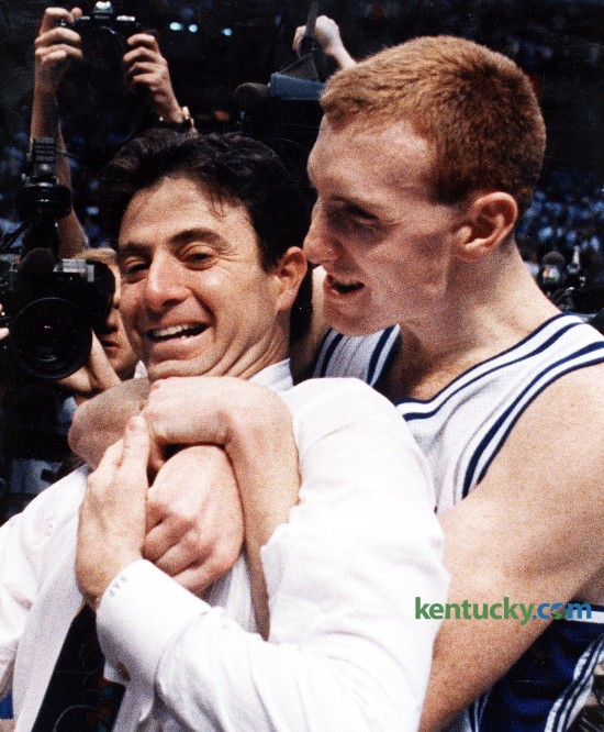 Kentucky basketball coach Rick Pitino is hugged by senior John Pelphrey after the Cats won the SEC Tournament, March 15, 1992 in Birmingham, Ala. UK stopped Alabama's three-year championship run with a stunning 80-54 victory behind the Cats' pressure defense and the Tide's emotionally draining one-point victory over Arkansas in the semifinals. The Tide did not roll as many in the crowd of 17,379 wanted. After a spirited 22 minutes, the Tide rolled over. Somewhere in the midst of UK's 30-6 second-half run, Bama point guard Elliot Washington made an awful confession to his UK counterpart. "Their point guard said, 'Look at those guys. They're quitting on me,' " Sean Woods said. Jamal Mashburn, the tournament's Most Valuable Player, scored 10 of his game-high 28 points in the run. Pelphrey, who joined Mashburn on the five-man All-Tournament team, was appreciative. "This is the great thing I've been able to do so far in athletics," he said. Photo by Charles Bertram | staff