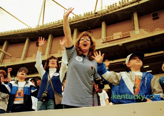 Corey Hendrick, 11, left, Noonan, Ga., Sandy Snapp, Falmouth, Ky., Lisa Johnting, also Falmouth, and Mason Baker, 10, LaCenter, Ky. cheered the Wildcats at the Goegia Dome in Atlanta during the NCAA Second Round game against St. Louis,  Sunday March 15, 1998. UK won 81-61 on their way to the NCAA Championship when they defeated Utah 78-69 in San Antonio. Photo by Michelle Patterson-Thomas | Staff