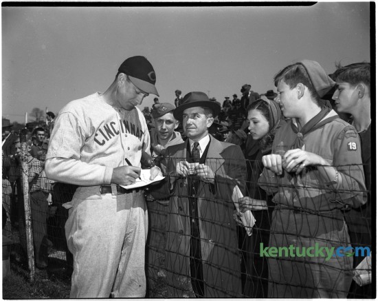A Cincinnati Red signed autographs before an exhibition game between the Cincinnati Reds and Boston Red Sox at the University of Kentucky's Stoll Field baseball diamond, April 9, 1946.  It was the first game ever played here by two major-league teams.  The training season exhibition title was taken by Cincinnati 4-2.  The crowd was estimated at 7,000-8,000.  