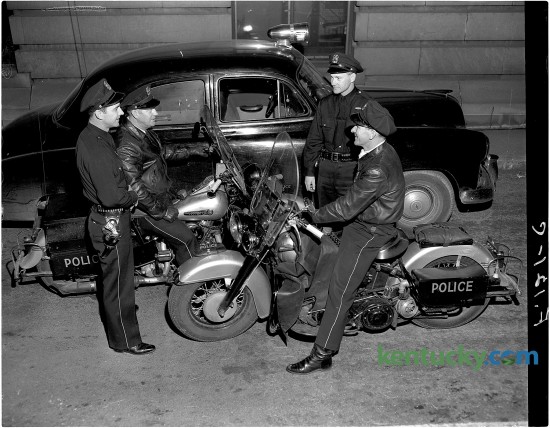 From left, Lexington policemen Lloyd Lindsay, Claude Ginter, William Foster and Bryan Henry chat. Published in the Herald-Leader January 14, 1951. Herald-Leader Archive Photo