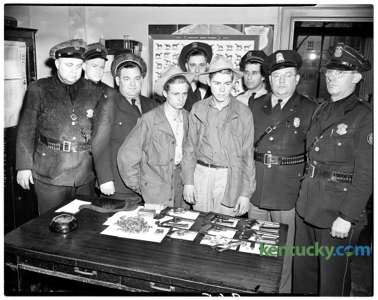 Albert Earl Little John, left, and Clayton Eversole were charged with looting a Berea hardware store in January, 1947. Guns and other items they took are on table in front of them. Published in the Lexington Leader January 31, 1947. Herald-Leader Archive Photo