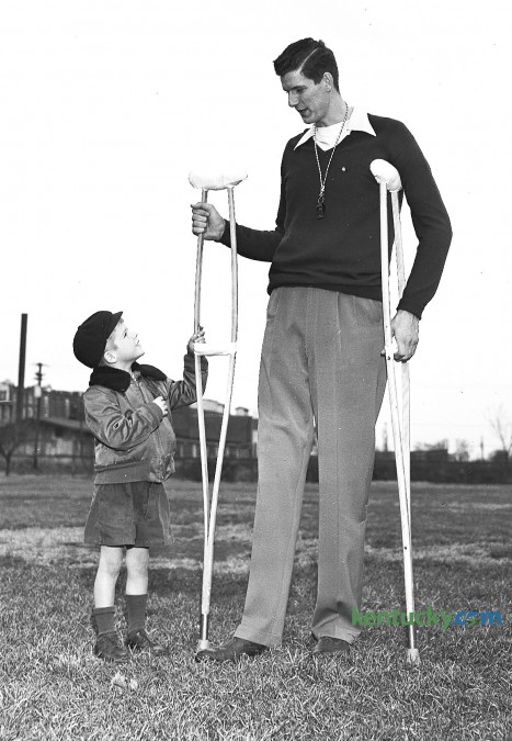 Six-year-old Ellis Harfford Jr. has a look at University of Kentucky basketball player Bill Spivey's cruthces, Nov. 13, 1951. The Wildcats All-American center underwent a knee operation three weeks prior to this photo. Spivey, UK's first 7-foot-tall player, had dreams of playing for the National Basketball Association, but those dreams were dashed after he was implicated in a point-shaving scandal in the early 1950s. Several current and former UK Wildcats of the era admitted they accepted money to shave points. But Spivey, who was indicted for perjury in the case, was adamant to the end of his life that he never had any part in attempts to fix college games. A New York trial jury voted 9-3 for acquittal, and the district attorney's office said it saw no use in trying the case again. But the damage was done. Although Spivey was never found guilty of any wrongdoing, he was barred from the NBA for life before he had a chance to play his first pro game. He went on to play for some minor professional teams, including a stint with a team opposing the Harlem Globetrotters. Herald-Leader archive photo