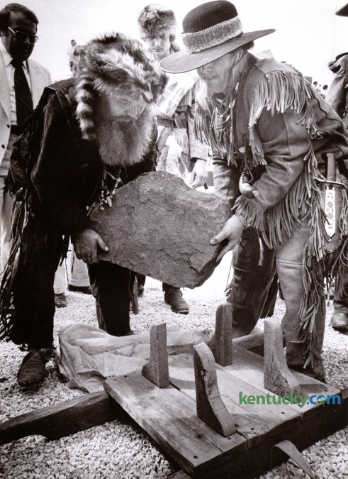 Pioneer Jim Williams, left, and an unidentified assistant, place the 200-pound cornerstone for the Lexington Civic Center on a wooden carrier during Lexington's Bicentennial Celebration Saturday June 14, 1975. The cornerstone came from the John Hancock House in Lexington, Massachusetts and was transported by Williams from there in a horse-drawn covered wagon. Lexington celebrated it's 200th birthday with a three-day festival which included a flag-raising, a parade, the cornerstone dedication, six stages of music and a prayer service. Photo by Ron Garrison | Staff