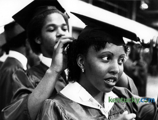 Felix Weathers adjusts Darlene Thornton's cap prior to the processional for the Bryan Station High School graduation May 30, 1981 at Rupp Arena. Bryan Station, Henry Clay and Paul Laurence Dunbar high schools celebrate the 2015 graduating class on May 31. Photo by David Perry | staff