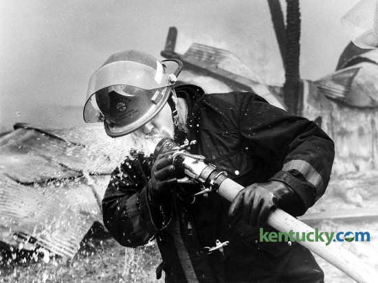 Lexington firefighter Billy Morgan takes a water break May 6, 1986 while fighting a tobacco warehouse fire on Virginia Ave. Photo by Frank Anderson | staff