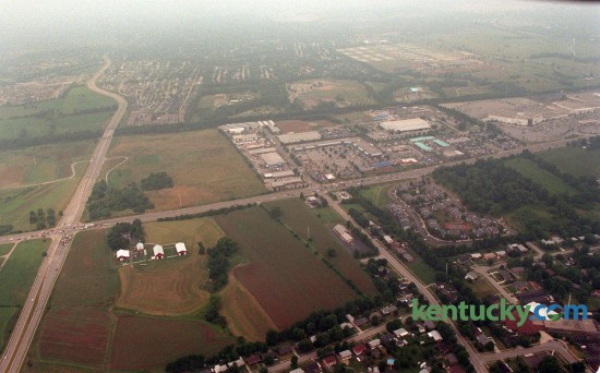 Aerial picture looking west, July 23, 1997, of the intersection of Nicholasville Road (left to right across the picture) and Man o'War Boulevard (on the left side running top to bottom). On the far right side the part of Fayette Mall that was McAlpin's (now Dillards) and on the far left is the South Farm property that is now a Wal-Mart and Lowe's. Picture was taken. The Man o'War and Nicholasville road interchange is located at left middle of picture. Towards the lower left side is Fritz Farm, future site of a shopping and residential center. Work on the $156 million, 60-acre Summit has been delayed, but developer Bayer Properties said the shopping and residential center is scheduled to open in fall 2016. New tenants signed for The Summit include: Brooks Brothers, upscale classic American apparel; J. McLaughlin, classic women's and men's sportswear and accessories; Orvis, country lifestyle clothier; Lily Rain, clothing and lifestyle store based in Houston and making its Kentucky debut; Lotus Boutique, affordable "boho" chic; new to Kentucky; Anthony Vincé Nail Spa; new to Lexington; Water + Oak, outdoor clothing, hiking, backpacking, climbing gear; new to Kentucky; Steel City Pops, a Birmingham, Ala.-based gourmet frozen-treat store; new to Kentucky; Texas de Brazil, an upscale Brazilian steakhouse; new to Kentucky; Ted's Montana Grill, opening its second restaurant in Lexington and Whole Foods, which would move from its current spot in Lexington Green to a 40,000-square-foot anchor position. Photo by Frank Anderson | staff