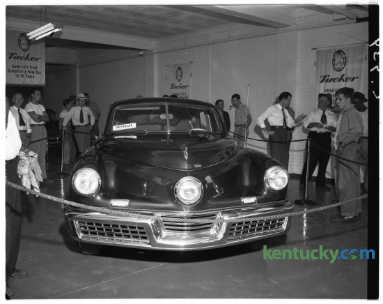 A Tucker 48 automobile on display at Adams Auto Sales in Lexington in August of 1948. The Tucker 48 (named after its model year) was an advanced automobile conceived by Preston Tucker and briefly produced in Chicago in 1948. Only 51 cars were made before the company folded in March of 1949. Some components and features of the car were innovative and ahead of their time. The most recognizable feature was a directional third headlight that would activate at steering angles of greater than 10 degrees to light the car's path around corners. The car had a rear engine and rear-wheel drive. A perimeter frame surrounded the vehicle for crash protection, as well as a roll bar integrated into the roof. The windshield was made of shatter-proof glass and designed to pop out in a collision to protect occupants. The remaining cars are sought after by collectors and can bring well over a million dollars at auction. Published in the Lexington Leader August 26, 1948. Herald-Leader Archive Photo
