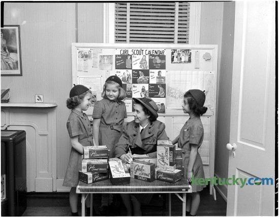 Girl Scouts get ready for cookie sale, Feb. 1951. From left, Mary Stewart McCabe, Tay Maxon, Mrs. Richard C. Jett and Grace Miller. Published in the Herald-Leader February 25, 1951. Herald-Leader Archive Photo